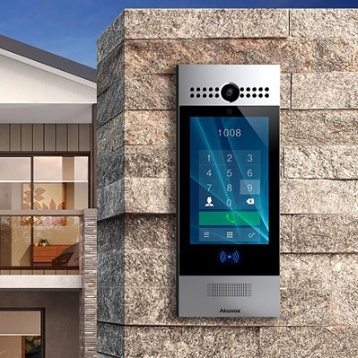 Wall-mounted Akuvox outdoor video intercom panel with camera, touchscreen keypad, and card reader
