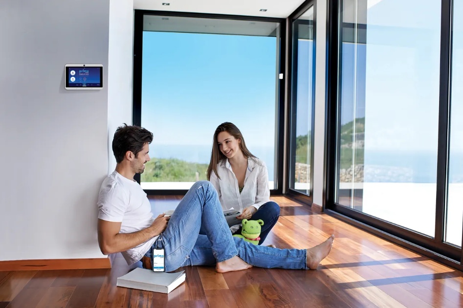 Smart home alarm panel and mobile monitoring app in a modern residential living space